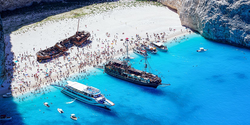 Enjoy at Navagio, one of the most amazing beaches in Greece in October.