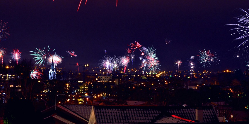 Two people holding sparklers, celebrating New Year events in the USA with joy