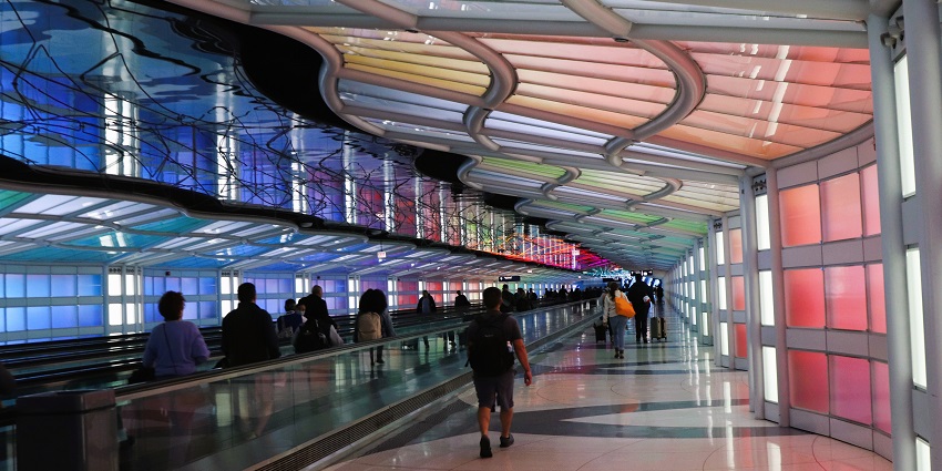 A view of an Airport terminal with planes and a busy runway in Chicago, a famous airport in Chicago.
