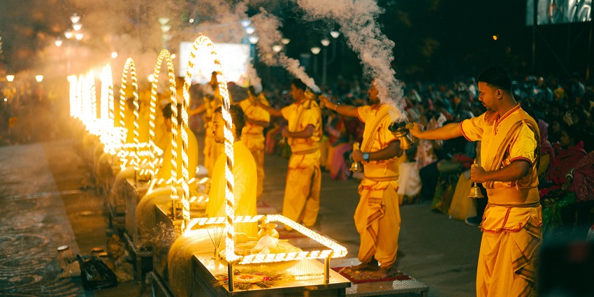 Multiple Hindu priests standing beside the altars, performing evening pooja and aarti.