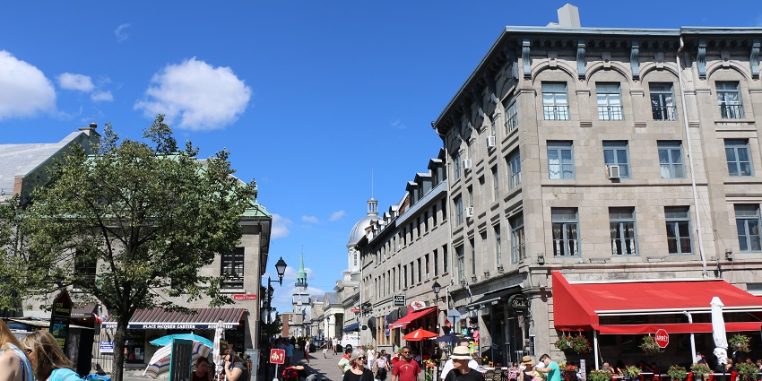 An image of Old Montreal (Vieux-Montréal) with historic buildings, and outdoor cafes.