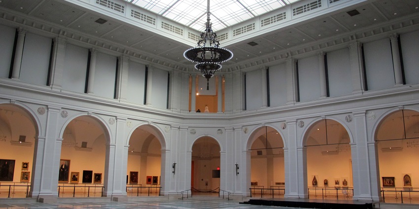 The courtyard of the Brooklyn Museum, featuring sculptures and greenery.