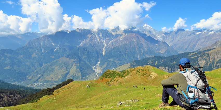 Image of man taking rest while hiking on the mountains - Carry modest clothes when visiting Palampur