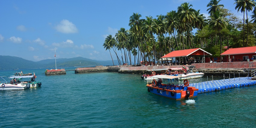 Image of Ross Island and boats near the deck also resting area under clear sky
