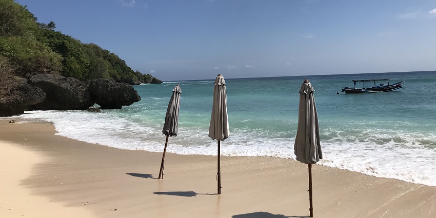 A picture of Padang Padang Beach, which is known for its surf and scenic views