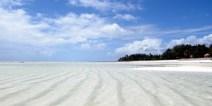 Around the time of low tide, the view of the Paje Beach being surrounded by clear water.