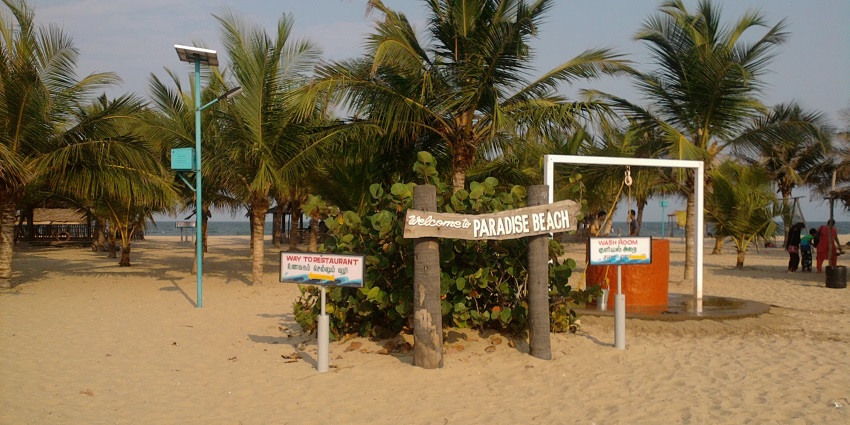 A signboard welcomes visitors to Paradise Beach near Chunnambar River in Pondicherry, India