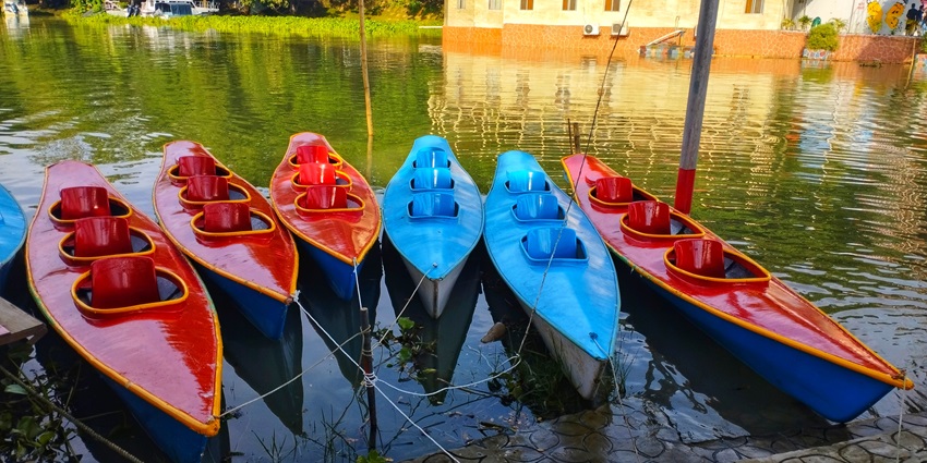 Panoramic image of a lake and various Kyakaing boats at the shore–Things To Do In Bangladesh