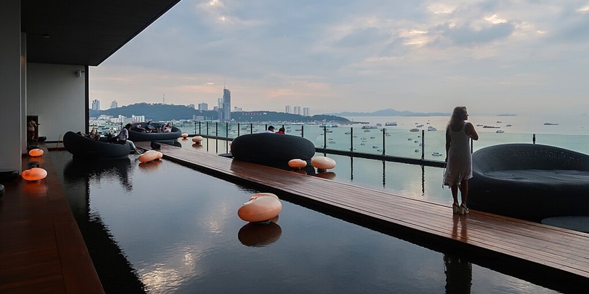 View of several boats dot Pattaya Bay in Thailand, as suggested by Thailand Travel Guide.