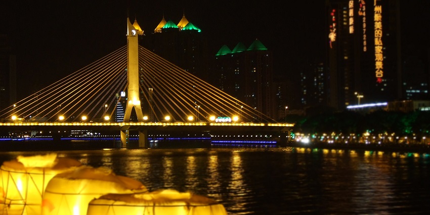 Image of Pearl River Night Cruise with colourful lights around the bridge and buildings