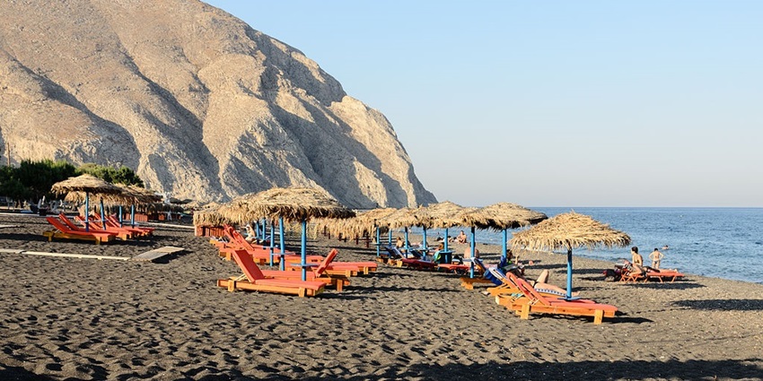 View of the Perissa Beach, with beautiful black sand and crystal-clear waters.