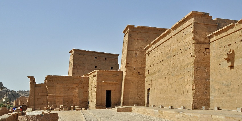 Philae temple with the ancient Egyptian detailed architecture and people exploring .