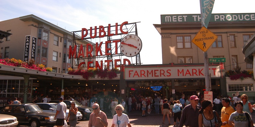 A view of the bustling Pike Place Market, where street vendors sell fresh fruits.