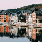 A view of the colourful houses near the lake - one of the places to visit in Belgium.