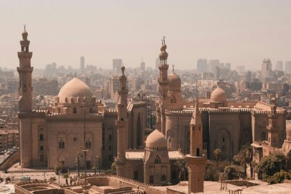 An aerial view of the Egyptian capital, Cairo, featuring a few buildings with domes.