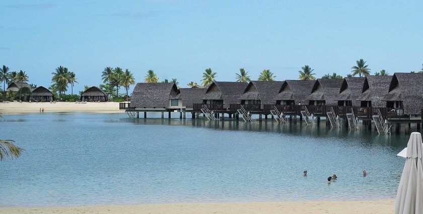 An Island is surrounded by pristine blue water - place to visit in Fiji