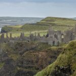 An Image of the Ruins of Dunluce Castle in Ballintoy, a must-see among the places to visit in Northern Ireland.