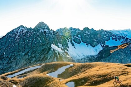 A panoramic view of Innsbruck, showcasing the old town, mountains, and alpine scenery.