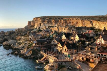 Beautiful houses on the sea shore are looking like a fairytale scene with a hill behind.