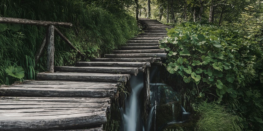 An image of the Plitvice Lakes waterfalls cascading through lush green landscapes.