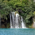 Plitvice Lakes National Park showcasing cascading waterfalls, and turquoise waters.