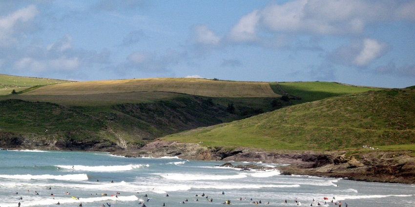 An image of Polzeath Beach, a prime surfing destination located in Cornwall, England.