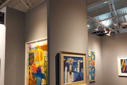 Vibrant artwork displayed in a modern gallery with visitors admiring the exhibits.