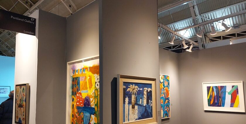 Vibrant artwork displayed in a modern gallery with visitors admiring the exhibits.