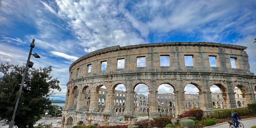 An image of the Pula Arena at sunset, one of the best places to visit in Croatia in July.
