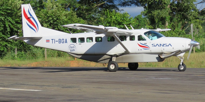 A Nature Air plane at an airstrip, showcasing one of the popular airports in Costa Rica.