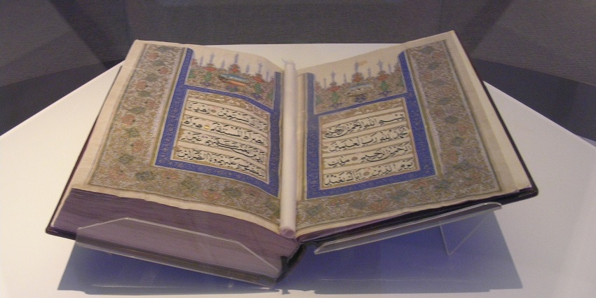 Exhibit featuring historical and artistic Quran manuscripts and artifacts.