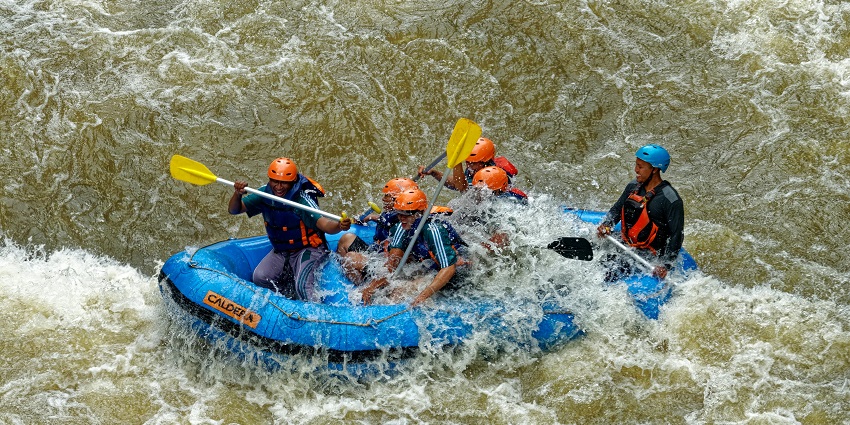 An image of a group of people rafting in a river.
