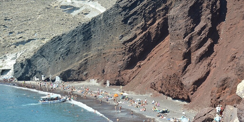 Relax at Red beach, one of the most amazing beaches in Greece in October.