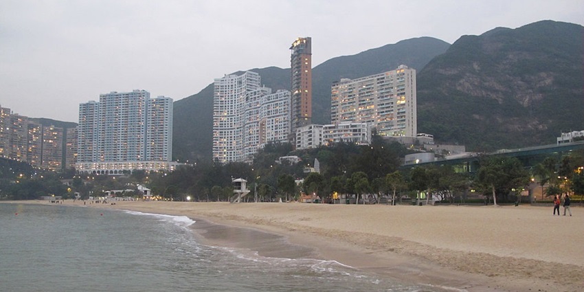 Scenic beach with clear waters and luxury apartment views.