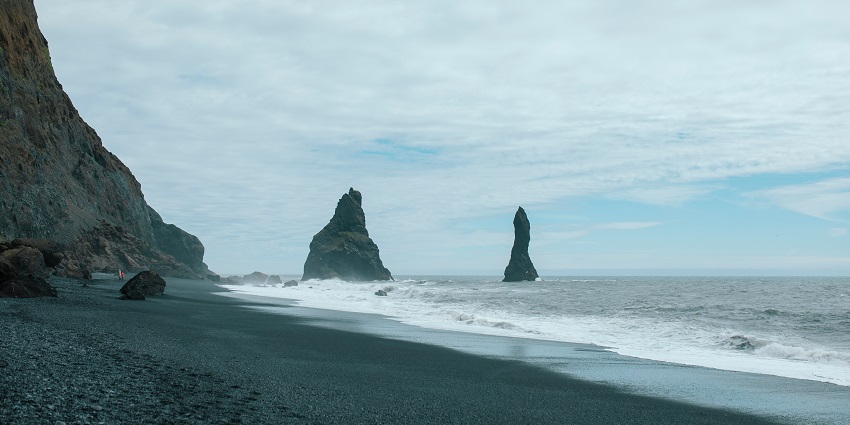 Image of Reynisfjara Black Sand Beach, featuring its unique volcanic sands and lovely waves.