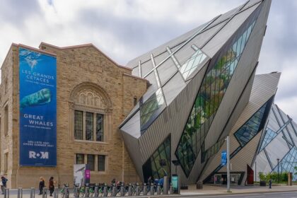 An image of an exterior view of the Royal Ontario Museum in the fall, showcasing modern architecture.