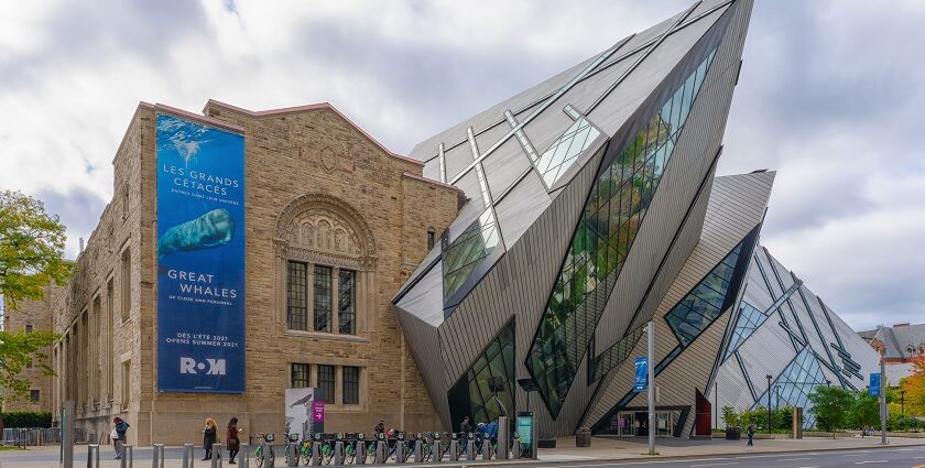 An image of an exterior view of the Royal Ontario Museum in the fall, showcasing modern architecture.