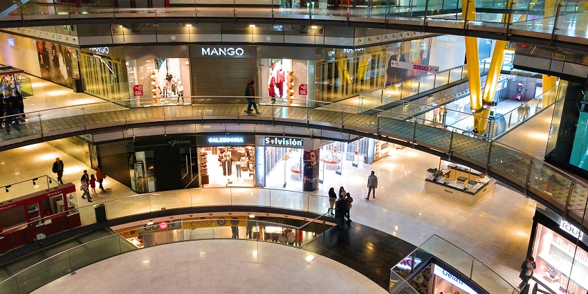 Image of a shopping mall interior - people walking inside building during daytime
