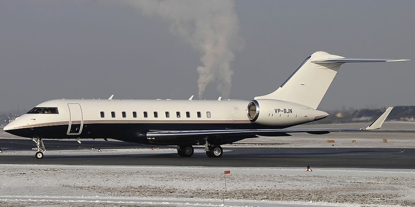 An image of a vintage Red Bull-branded Douglas DC-6 aircraft displayed at Salzburg Airport, a famous airport in Austria
