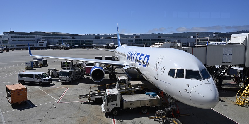 A United Airlines Boeing 757-200 at a gate at one of the well-known international airports.