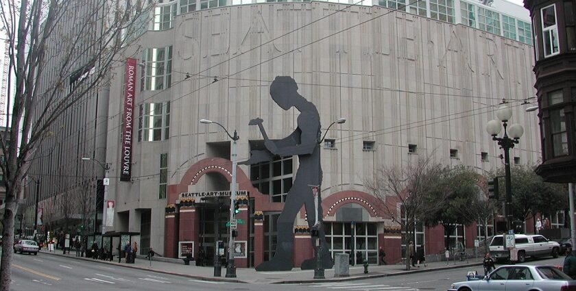 A picture of the Seattle Art Museum with modern architecture in contrast to the city skyline.