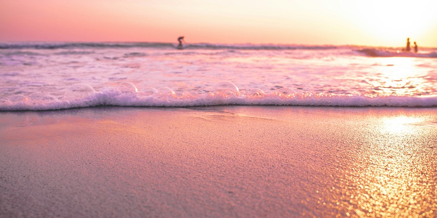 Numerous tourists gather at Seminyak Beach, a place to visit on the Bali travel guide.