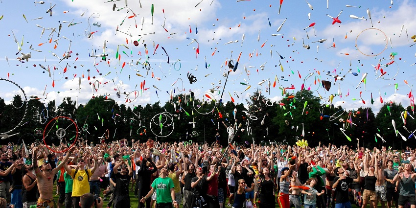 An image of the people throwing pins and enjoying the Shambhala festival in England.