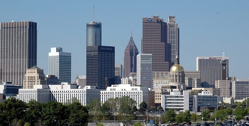 A view of the Skyline of Atlanta at dusk, showcasing tall buildings and city lights under a vibrant sky.