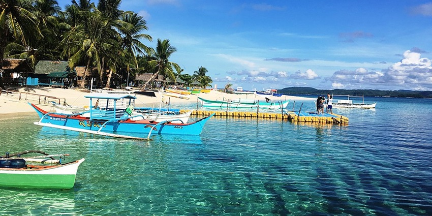 Tropical paradise is known for surfing, palm-fringed beaches, and lagoons
