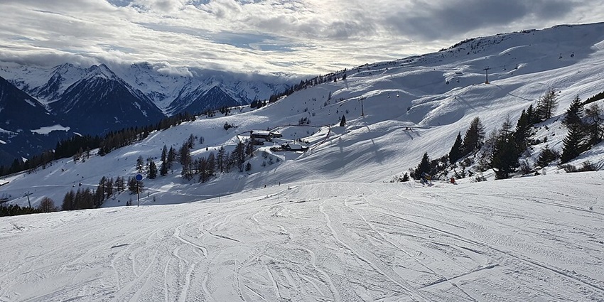 A simple view of skiers enjoying the snowy slopes of the Kitzbühel Alps in Austria