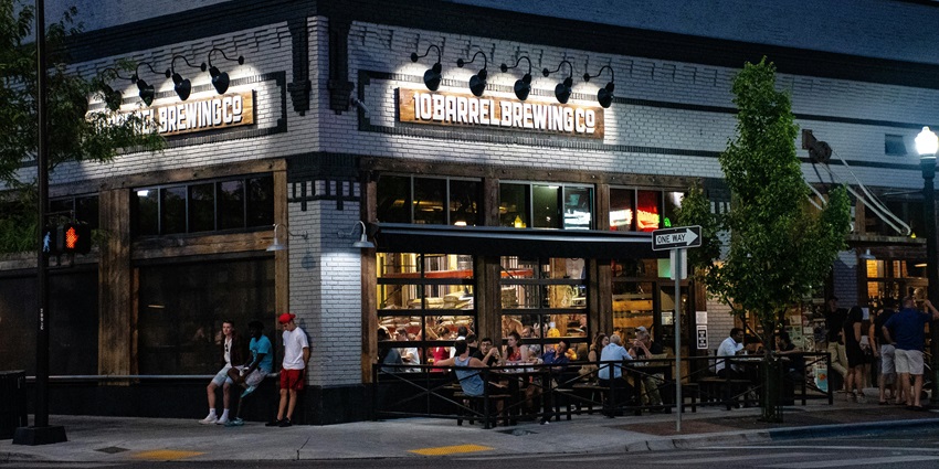 Image of a group of people sitting outside the cafe on the chairs