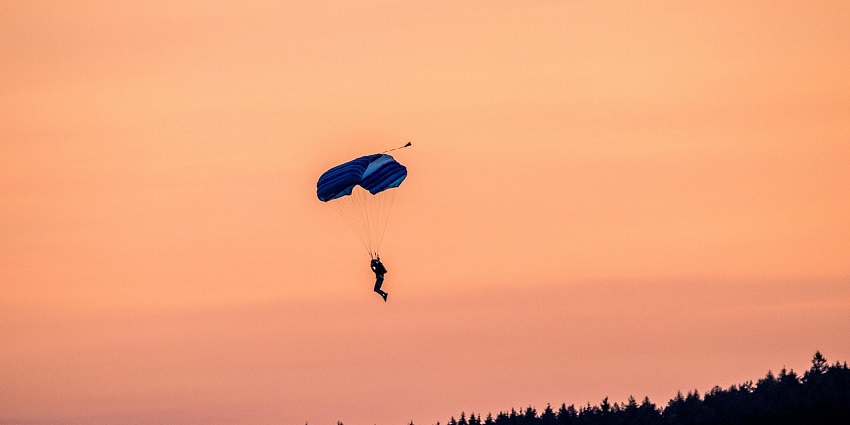 An image showing a person skydiving, capturing the thrill and freedom of the jump