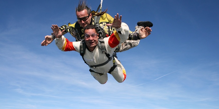 An image showing two people skydiving together, experiencing an exciting and adventurous dive