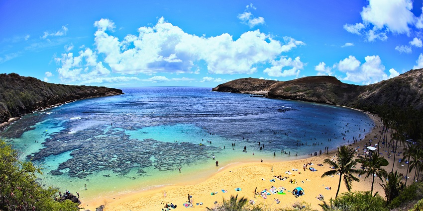 An aerial view of Hanauma Bay shows people enjoying the beach in Oahu, Hawaii.